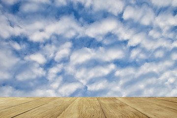 Fototapeta na wymiar Empty top wooden table on clouds sky for background