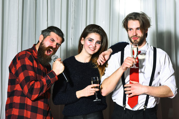 Happy friends celebrating at karaoke party