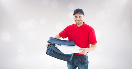 Delivery man removing pizza box from bag