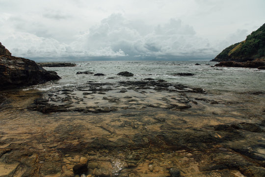 precipice is a sea view. Storm sky, power. Stones in the sea.