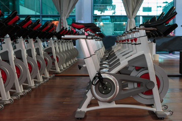 Fitness Workout in Gym: Group of Modern Spinning Bikes in Line