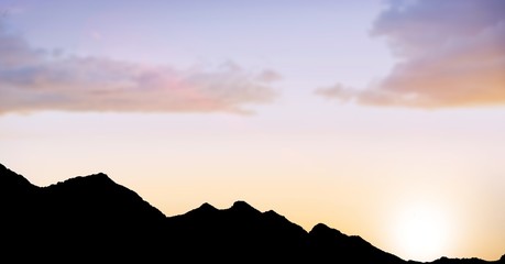 Silhouette hills against sky during sunset