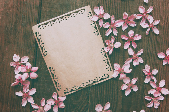 Note, postcard, writing of peach tree flowers on a wooden vintage table
