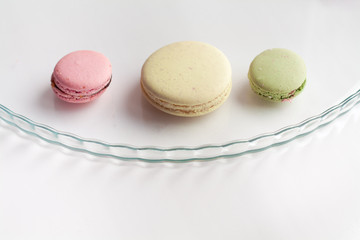 Three macaroons on glass plate