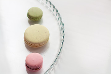 Three macaroons on glass plate