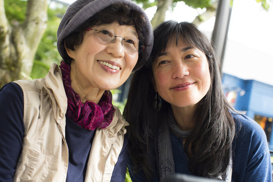 Portrait of smiling older Japanese mother and daughter 