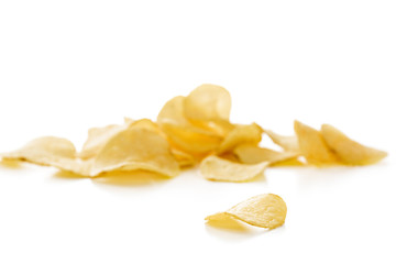 Crispy potato chips isolated on white background  close-up