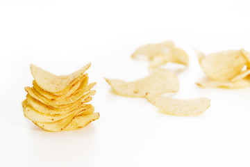 Crispy potato chips isolated on white background  close-up