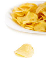 Crispy potato chips isolated on white background  close-up