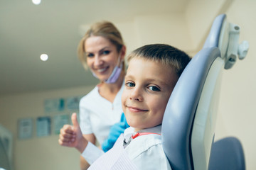 Little cute boy at the dentist looking at the camera and smiling