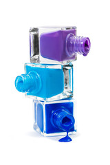 Stack of blue nail polish isolated on white background