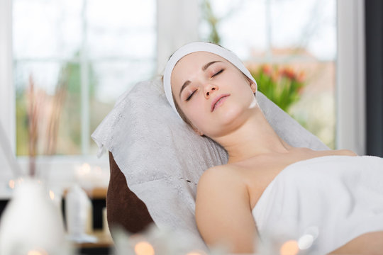 Young woman lying at beautician's and waiting for spa treatment
