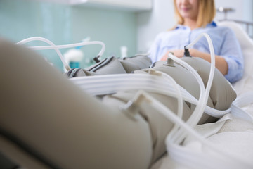 Woman receiving slimming lymphatic drainage treatment at beautician's