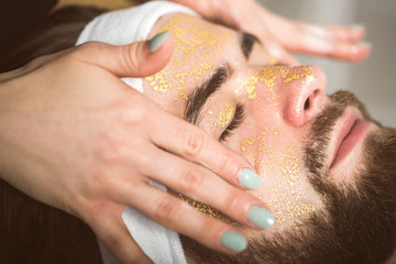 Men's gold mask therapy at beautician's