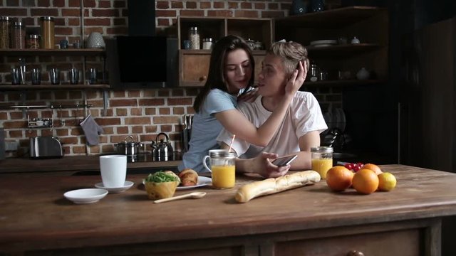 Happy couple in love embracing in the kitchen