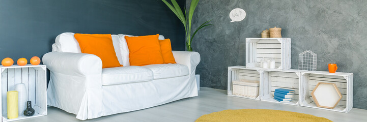Sofa with orange cushions