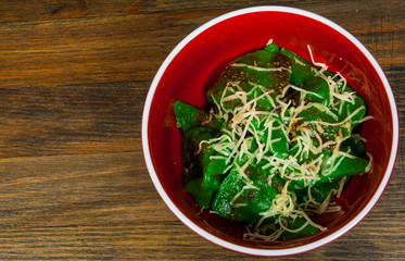 Green ravioli with spinach on a wooden background with copy space. top view