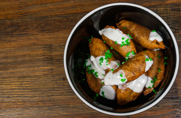  Fried Ravioli with Sauce on a wooden background. with copy space. top view