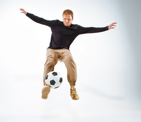 Fototapeta premium A portrait of a fan with ball on gray studio background. Freestile
