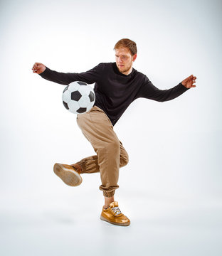 A portrait of a fan with ball on gray studio background. Freestile