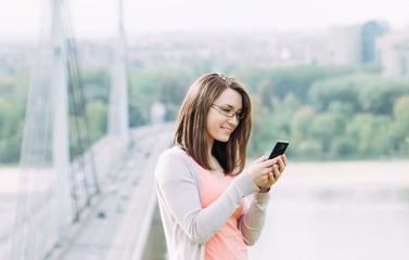 Young woman using smartphone outdoor in city