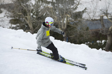 Fototapeta na wymiar Skier in mountains, prepared piste and sunny day