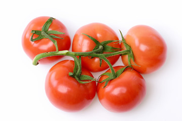 Tomatoes. Red ripe vegetable plant on branch