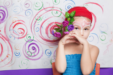 Obraz na płótnie Canvas Portrait of a child with flowers 