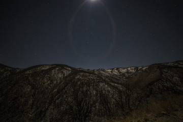 stars and moonlight over a mountain range 