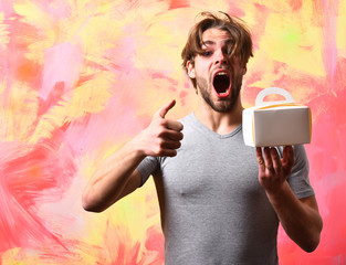 Caucasian bearded sexy macho man holding meal box
