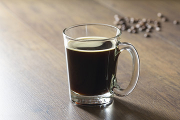 Hot black americano coffee in transparent glass cup