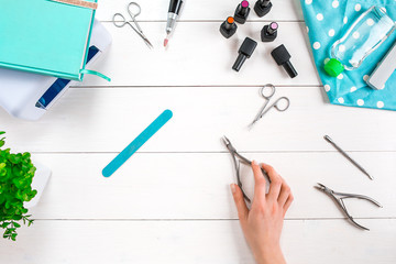 Manicure set and nail polish on wooden background