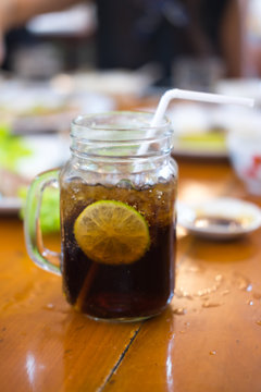 Glass of cola with lemon slice
