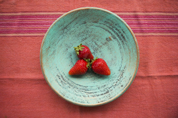 Three strawberries on a plate