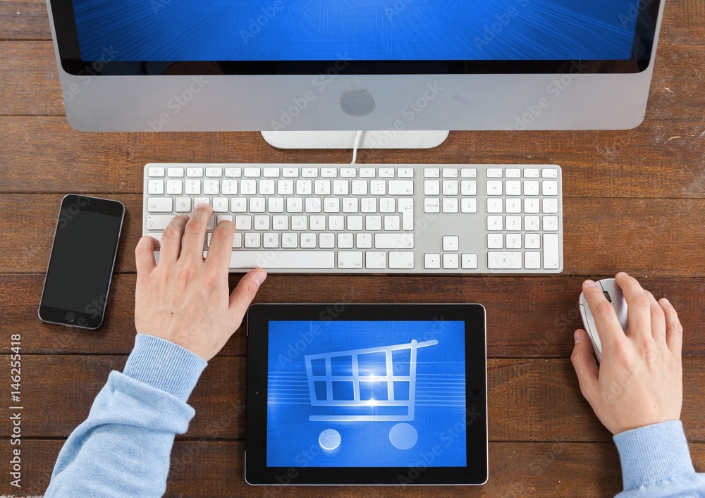 Poster person using tablet and computer with shopping trolley icon