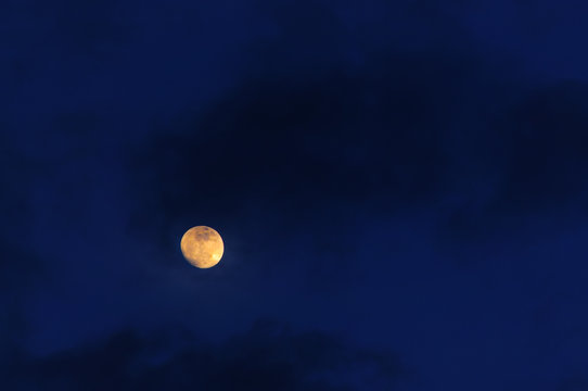 Dark Blue Sky With Full Moon And Storm Clouds