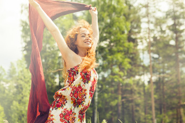 Caucasian woman holding scarf in wind