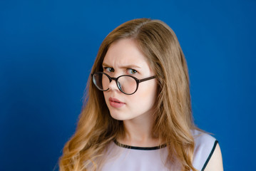 Fototapeta premium A girl with glasses is surprised