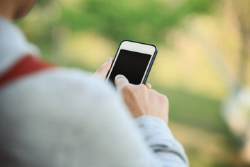 closeup of hands using smartphone taking photo outdoor