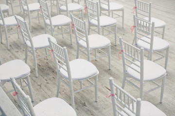 Look from above at white chairs standing on white porch