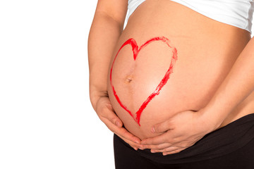 Red heart painted on belly of pregnant woman