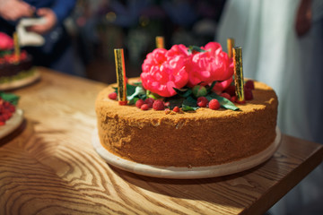 Chocolate cake decorated with red peonies