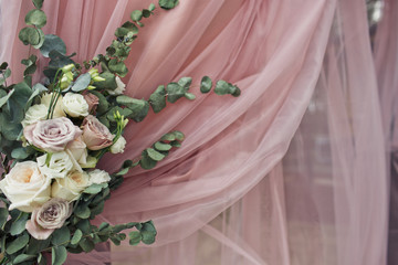 Pastel pink and white roses on pink dinner table