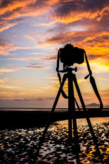 Camera and tripod on the sunset