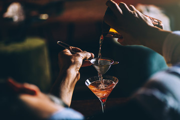 Barman is making cocktail at night club. - 146260435