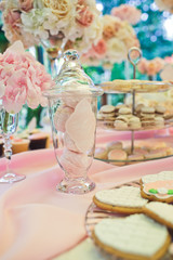 Cookies in tall glass vase on pink table