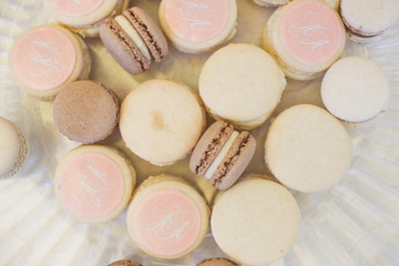 Pink and white macaroons on glass plate