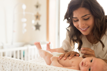 Obraz na płótnie Canvas Mother moisturizing baby