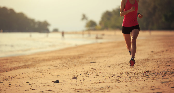 healthy lifestyle woman runner running at seaside