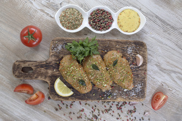 Chicken fillet in marinade on wooden board. 